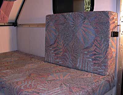 Seat with cushion back retained